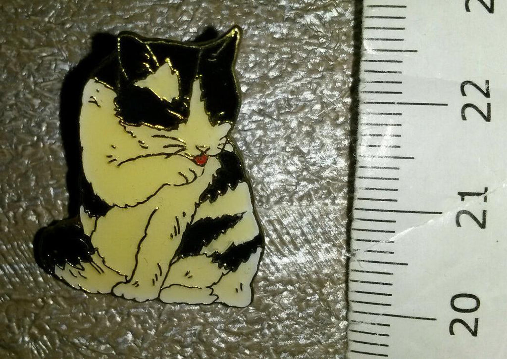 Cat Black and White licking its Paws Pin